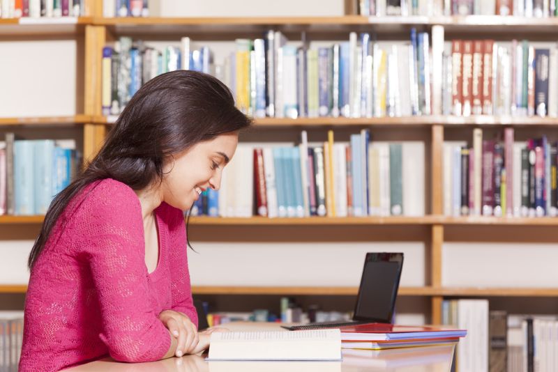 immigrant woman studying in library